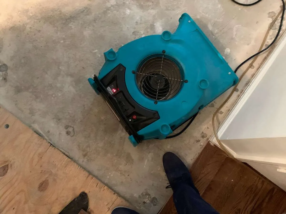 Air mover drying subfloor during Commercial Water Damage Restoration in Lake Station